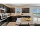 Well-equipped kitchen with granite countertops, dark cabinets, and a large island with bar seating at 1210 Alstonia Ln, Mount Dora, FL 32757