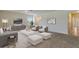 Spacious living room featuring modern furniture, neutral tones, and an open layout connecting to other areas of the house at 1210 Alstonia Ln, Mount Dora, FL 32757