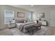 Serene main bedroom featuring a large bed, a window overlooking the property, and modern decor at 1210 Alstonia Ln, Mount Dora, FL 32757