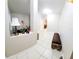 Inviting entryway with neutral tones, tile flooring, decor, and a bench for comfortable seating at 14448 Pleach St, Winter Garden, FL 34787