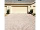 Spacious three car garage with a brick driveway and well-manicured landscaping at 14448 Pleach St, Winter Garden, FL 34787