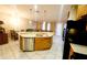Kitchen island featuring stainless steel sink, dishwasher, wood cabinets, and modern pendant lighting at 14448 Pleach St, Winter Garden, FL 34787