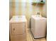 Functional laundry area with washer, dryer, and shelving at 14448 Pleach St, Winter Garden, FL 34787