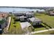 Stunning aerial view of a luxury waterfront home with manicured lawn and paver driveway at 14544 Avenue Of The Rushes, Winter Garden, FL 34787