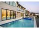 Stunning backyard features a modern pool and spa, perfect for relaxation and entertaining, with views of the home's architecture at 14544 Avenue Of The Rushes, Winter Garden, FL 34787