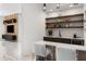 Stylish bar area with modern shelving, seating, and a built-in sink at 14544 Avenue Of The Rushes, Winter Garden, FL 34787