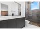 Modern bathroom features a frameless glass shower, a sleek vanity, and large mirror with ample natural light at 14544 Avenue Of The Rushes, Winter Garden, FL 34787