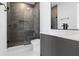 Sleek bathroom showcasing walk-in shower with gray tile and frameless glass enclosure at 14544 Avenue Of The Rushes, Winter Garden, FL 34787