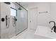Sleek bathroom features a glass-enclosed shower, soaking tub, and stylish matte black fixtures at 14544 Avenue Of The Rushes, Winter Garden, FL 34787