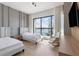Stunning bedroom with a serene water view, featuring two beds, a rocking chair, and hardwood floors at 14544 Avenue Of The Rushes, Winter Garden, FL 34787