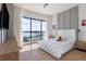 Bright bedroom with large window overlooking the lake, plush bed, and stylish decor at 14544 Avenue Of The Rushes, Winter Garden, FL 34787