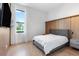 Comfortable bedroom featuring a gray bed frame, hardwood floors, and minimalist decor at 14544 Avenue Of The Rushes, Winter Garden, FL 34787