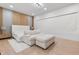 Cozy bedroom with a white sofa and ottoman, plush bed, and contemporary design at 14544 Avenue Of The Rushes, Winter Garden, FL 34787