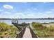Stroll along this wooden walkway to reach the private dock and enjoy waterfront views from your beautiful home at 14544 Avenue Of The Rushes, Winter Garden, FL 34787