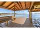 Lakefront home's covered boat dock offers seating and a lift for easy water access at 14544 Avenue Of The Rushes, Winter Garden, FL 34787