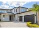 Modern two-story home with a three-car garage, clean lines, and well-maintained landscaping for curb appeal at 14544 Avenue Of The Rushes, Winter Garden, FL 34787