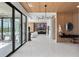 Sleek foyer featuring modern lighting, wood paneling, and expansive views into the living spaces at 14544 Avenue Of The Rushes, Winter Garden, FL 34787