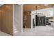 Bright foyer with modern light fixture, marble floors, and open access to the kitchen at 14544 Avenue Of The Rushes, Winter Garden, FL 34787
