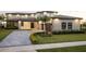 Beautifully landscaped front yard with paver driveway leading to a modern two-story home at 14544 Avenue Of The Rushes, Winter Garden, FL 34787