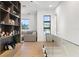 Hallway featuring glass railings, hardwood floors, built-in shelving, and natural light at 14544 Avenue Of The Rushes, Winter Garden, FL 34787