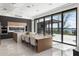 Bright, modern kitchen with a center island, dining table, and sliding glass doors to a covered patio with a lake view at 14544 Avenue Of The Rushes, Winter Garden, FL 34787