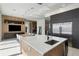 Open-concept kitchen features an island with a sink, modern cabinetry, stainless steel appliances, and a view into the dining area at 14544 Avenue Of The Rushes, Winter Garden, FL 34787