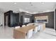 Modern kitchen with sleek cabinetry, island with seating, and wine cellar adjacent to the dining area at 14544 Avenue Of The Rushes, Winter Garden, FL 34787