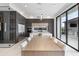 Modern kitchen with sleek cabinetry, island with seating, and wine cellar adjacent to the dining area at 14544 Avenue Of The Rushes, Winter Garden, FL 34787