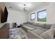 Bright living room featuring a large sectional sofa and an entertainment center with a wall-mounted TV at 14544 Avenue Of The Rushes, Winter Garden, FL 34787