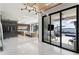Modern living room flows into an open kitchen with an island and patio with lake views at 14544 Avenue Of The Rushes, Winter Garden, FL 34787