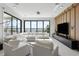 Bright living room with marble floors, large windows with lake views, and modern white seating at 14544 Avenue Of The Rushes, Winter Garden, FL 34787