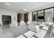 Bright living room featuring a large white sectional sofa, floor-to-ceiling windows, and an open layout at 14544 Avenue Of The Rushes, Winter Garden, FL 34787