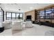 Bright living room featuring a large white sectional sofa, floor-to-ceiling windows, and an entertainment center at 14544 Avenue Of The Rushes, Winter Garden, FL 34787