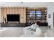 Bright living room featuring white chairs, an entertainment center with shelving, and marble floors at 14544 Avenue Of The Rushes, Winter Garden, FL 34787