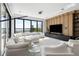 Bright living room featuring a large white sectional sofa, floor-to-ceiling windows, and an entertainment center at 14544 Avenue Of The Rushes, Winter Garden, FL 34787