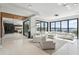 Bright living room featuring a large white sectional sofa, floor-to-ceiling windows, and an open layout at 14544 Avenue Of The Rushes, Winter Garden, FL 34787