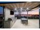 Back exterior with an outdoor kitchen featuring a grill and dining area, perfect for entertaining guests at 14544 Avenue Of The Rushes, Winter Garden, FL 34787