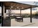 Outdoor entertainment area featuring a grill, dining table, and serene lake views at 14544 Avenue Of The Rushes, Winter Garden, FL 34787