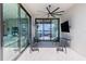 Inviting covered patio featuring comfortable seating, ceiling fan, and picturesque waterfront views at 14544 Avenue Of The Rushes, Winter Garden, FL 34787