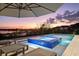 Scenic pool area with a spa, perfect for evening relaxation with captivating sunset views over the lake at 14544 Avenue Of The Rushes, Winter Garden, FL 34787