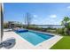 Stunning waterfront property featuring a modern pool and hot tub with lakeside view at 14544 Avenue Of The Rushes, Winter Garden, FL 34787