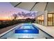 Stunning modern pool and hot tub with lake view and deck at sunset at 14544 Avenue Of The Rushes, Winter Garden, FL 34787