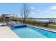 This backyard boasts a beautiful pool and outdoor kitchen, perfect for entertaining guests and enjoying waterfront living at 14544 Avenue Of The Rushes, Winter Garden, FL 34787