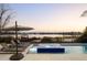 Relaxing hot tub and pool area with stunning lake views at sunset at 14544 Avenue Of The Rushes, Winter Garden, FL 34787