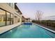 Backyard pool with infinity edge, sun loungers, and an outdoor entertainment area at 14544 Avenue Of The Rushes, Winter Garden, FL 34787