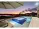 Modern blue tiled pool and hot tub overlooking the lake at sunset at 14544 Avenue Of The Rushes, Winter Garden, FL 34787