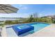 Enjoy a stunning lake view from this beautiful pool and blue tiled hot tub perfect for relaxing and entertaining guests at 14544 Avenue Of The Rushes, Winter Garden, FL 34787