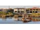 Waterfront home featuring a lakeside dock and bridge at 14544 Avenue Of The Rushes, Winter Garden, FL 34787