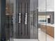 Modern glass-enclosed wine cellar features dark gray walls and contemporary metal wine racks at 14544 Avenue Of The Rushes, Winter Garden, FL 34787