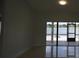 Screened back porch area with a view of the lake and access to the patio and fire pit at 14712 Eagles Crossing Dr, Orlando, FL 32837